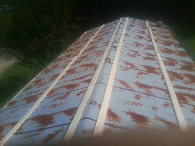 Rusted metal roof panels with new wood purlins before replacement — Storm Damage Roof Repair in Dedham by Roofing Brothers